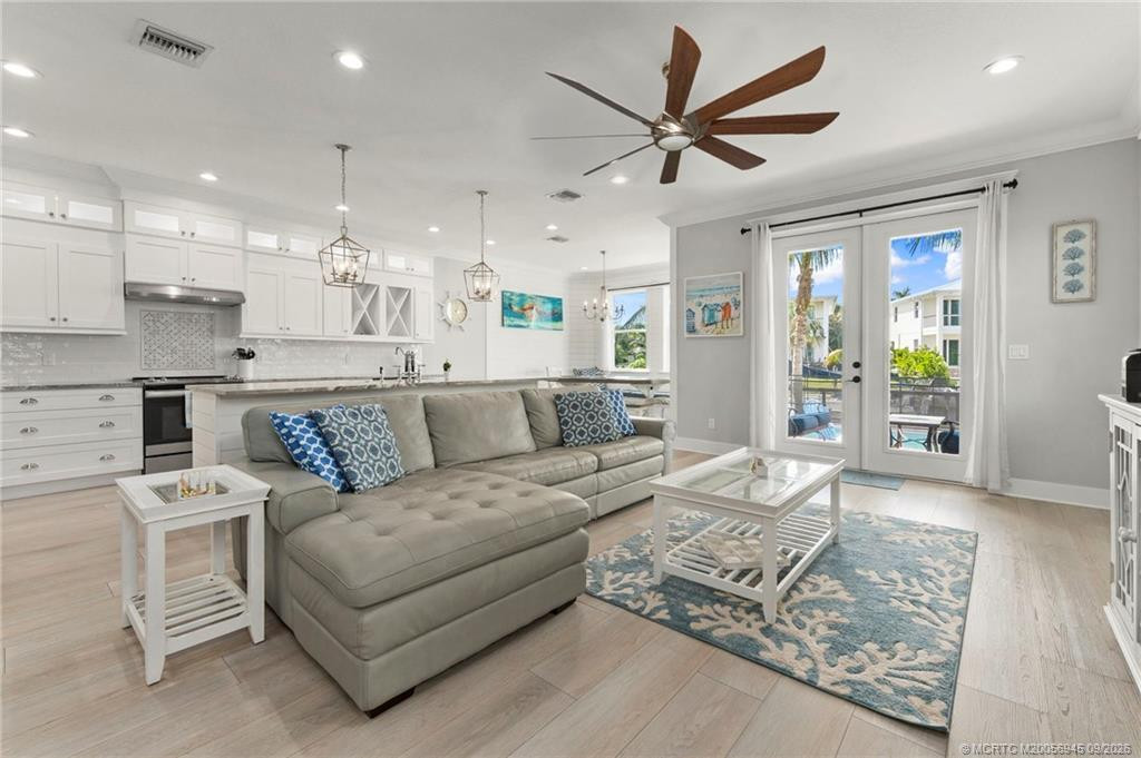 Living Room leads to Deck, Pool, and Canal