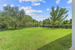 The large fenced yard backs up to the preserve