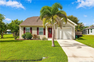 Alternate view of front elevation showing driveway and palm tree landscaping