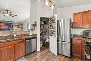 Large Walk-In Pantry Kitchen with stainless refrigerator and ample cabinet storage