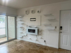 ELECTRIC FIREPLACE. HURRICANE WINDOWS AND SHUTTERS. THIS IS THE FRONT DOOR.