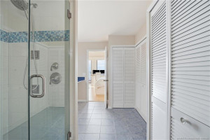 Spacious primary bath offers generous closet storage and a large walk-in shower, with direct access to the primary suite.