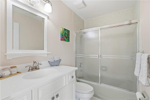 Full guest bathroom features a large vanity and tub/shower combination.