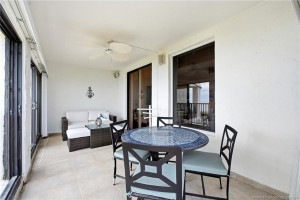 Generous covered outdoor living space offers room for both dining and lounging just steps from the ocean.