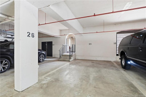 Dedicated covered garage parking space #26.
