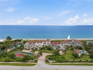 Aerial perspective showcasing The Dune's intimate oceanfront setting with community tennis and pool amenities.