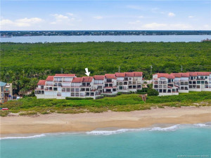 Aerial view identifying the residence with the Atlantic Ocean in the foreground and Indian River in the distance.