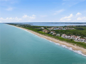 Expansive aerial perspective showcases miles of coastline with the Atlantic Ocean and Indian River framing Hutchinson Island.