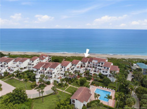 Aerial view of The Dune showcasing its low-density oceanfront setting, community pool, and direct beach access.