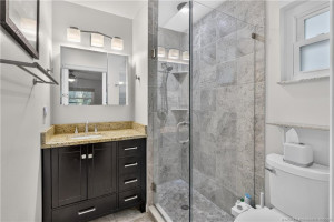 Glass-enclosed shower with tasteful tilework