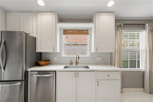 Quartz countertops with herringbone tile backsplash