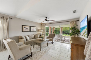 Family room with access to the screened and covered patio with lake views