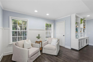A cozy sitting area within the family room with custom built-ins creates a welcoming retreat for reading or conversation