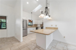 Peninsula for extra counter and cabinet storage.