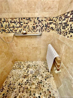 Walk in shower w/custom stone floor & walls
