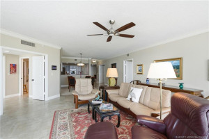 Generously sized living area with neutral tile flooring and an open layout ideal for entertaining.