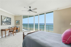 Wake up to breathtaking Atlantic Ocean views from this spacious primary bedroom with floor-to-ceiling glass.