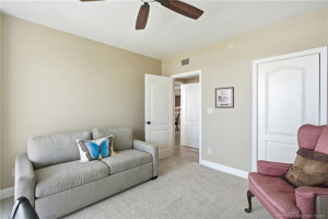 Bright and spacious oceanfront room featuring sliding glass doors, balcony access, and beautiful beach and ocean views.