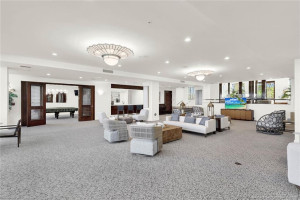 Bright and spacious oceanfront lounge offering multiple seating areas and floor-to-ceiling windows showcasing the beautiful coastal setting.