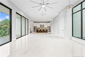 Upstairs Living and Dining Area Leading to the Balcony and Overlooking the Pool
