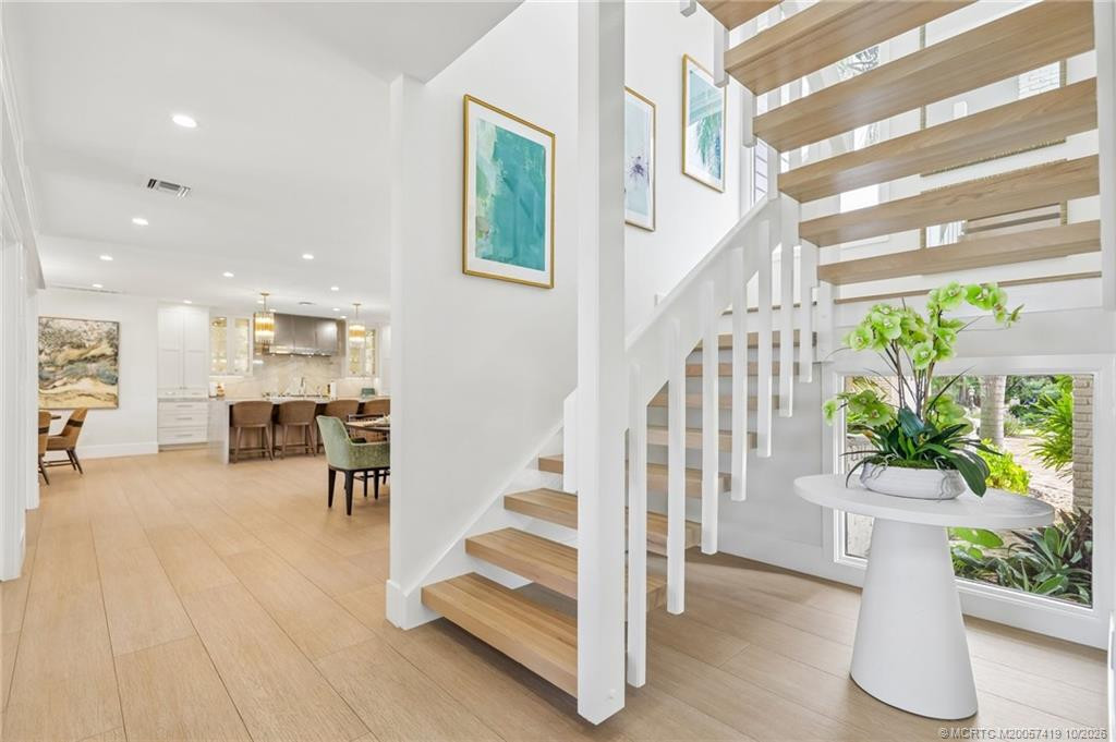 Modern staircase invites you to the owner's suite