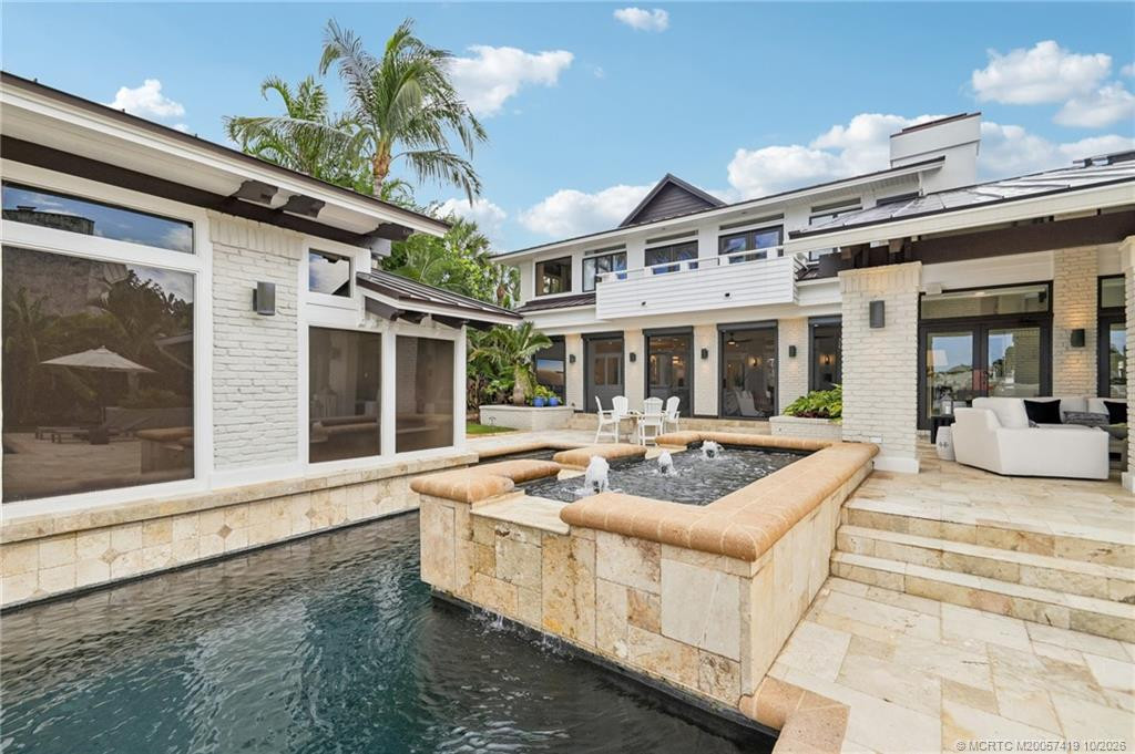 Expansive outdoor living with pool, cascading spa and covered veranda