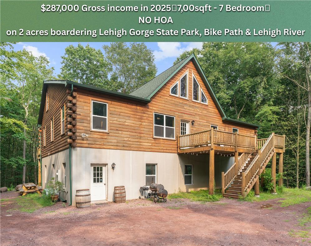 Log exterior siding and a spacious elevated wooden deck define this rustic multi-level home. Log exterior siding and a spacious elevated wooden