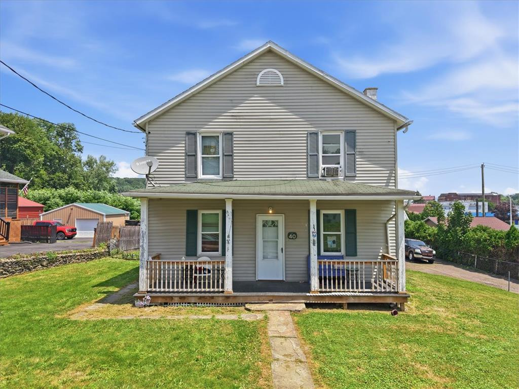 Classic siding exterior and a welcoming covered front porch define this traditional home design. Classic siding exterior and a welcoming covered fr