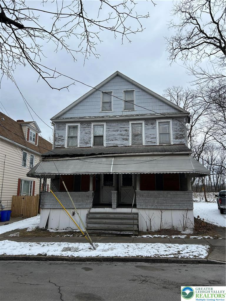 A classic facade with a welcoming porch awaits, offering dual entrances. A classic facade with a welcoming porch awaits, of
