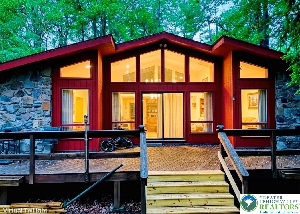 A charming rustic retreat nestled amongst lush trees, featuring a spacious outdoor deck perfect for entertaining. A charming rustic retreat nestled amongst lush tre