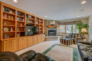 Photo for 4611 Bayswater Road, Excelsior, MN 55331 - Listing #5725865 Lower level with gas burning fireplace, full wall of built ins and look out windows.