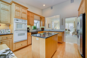 Photo for 4611 Bayswater Road, Excelsior, MN 55331 - Listing #5725865 Cooktop Stove in Granite-Topped Island. Stainless Steel Refrigerator and Pass-Through Window to dining Room