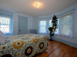 Photo for 3655 Pleasant Avenue, Minneapolis, MN 55409 - Listing #6006077 First of four spacious bedrooms on upper level has southern exposure. Curved wall of windows.