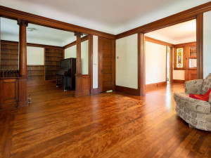 Photo for 3655 Pleasant Avenue, Minneapolis, MN 55409 - Listing #6006077 Looking into the library/family room from the living room with stately pillars. Door leads to the stair case to the second floor. Upright Piano stays with home(in great shape)