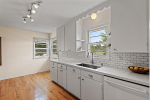 Photo for 4753 Abbott Avenue S, Minneapolis, MN 55410 - Listing #6028078 Kitchen with newer granite counters, sink, faucet, subway tile and Bosch dishwasher