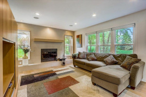 Photo for 16634 Imperial Court, Lakeville, MN 55044 - Listing #6098405 Spacious sun-filled living room features a cozy wood-burning fireplace for added warmth & ambiance with tiled wall surround, built-in wood mantle + side and backyard views.