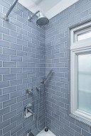 Photo for 615 8th Avenue SW, Rochester, MN 55902 - Listing #5748504 Waterfall shower with beautiful subway tile surround.