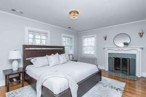 Photo for 615 8th Avenue SW, Rochester, MN 55902 - Listing #5748504 Master bedroom with elegant wood-burning fireplace and hardwood floors.