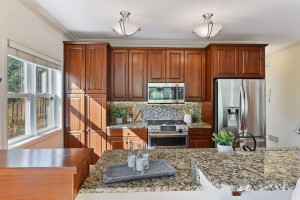 Photo for 4438 Thomas Avenue S, Minneapolis, MN 55410 - Listing #6088133 The kitchen offers custom cabinets, granite countertops and stainless-steel appliances.