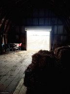 Photo for 90917 240th Street, Austin, MN 55912 - Listing #6176986 Overhead door in hay loft to bring in- or push out hay for your furry friends.