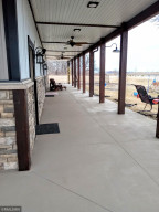 Photo for 90917 240th Street, Austin, MN 55912 - Listing #6176986 This patio is over 70' long! It runs down the entire side of the big shed and partially wraps around the front of the building as well. Overlooking your pasture area.
