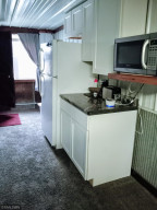 Photo for 90917 240th Street, Austin, MN 55912 - Listing #6176986 Full Kitchen - stove has been removed from here. Just past the fridge is the other set of stairs to go to the guest suite.
