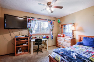 Photo for 7812 29th Street N, Oakdale, MN 55128 - Listing #6193596 Second bedroom on this level, shown here with a twin-sized bed. Nice view out to the back yard!