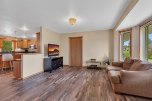 Photo for 714 5th Street NW, Richmond, MN 56368 - Listing #6199191 Living room has large bay window and door on far side opens to a bedroom or office.