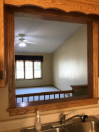 Photo for 130 Orchard Manor Drive SE, Plainview, MN 55964 - Listing #6222168 peek through into living room from kitchen