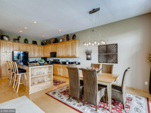Photo for 19860 Dawson Lane, Farmington, MN 55024 - Listing #5613852 Beautiful kitchen with maple cabinets, maple hardwood floors and breakfast bar with contrasting black granite counter tops. Large formal dining area with access to elevated deck and fantastic views. Great space for entertaining.