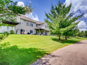Photo for 19860 Dawson Lane, Farmington, MN 55024 - Listing #5613852 Rear elevation with the start to one of the walking trails through the attached woods and wetland area.