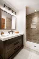 Photo for 835 Hunt Farm Road, Long Lake, MN 55356 - Listing #5693151 The third bedroom features this ensuite bathroom with Carrara marble countertop, custom designed lighting and faucet, and designer tile shower surround.