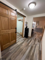 Hallway with new barn door on laundry room