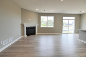 Photo for 13205 Deerwood Lane N, Dayton, MN 55327 - Listing #6097796 The main level also features this family room, which is large enough to accommodate just about any furniture configuration and is highlighted by a corner gas fireplace! (Photo of same plan, colors are similar)